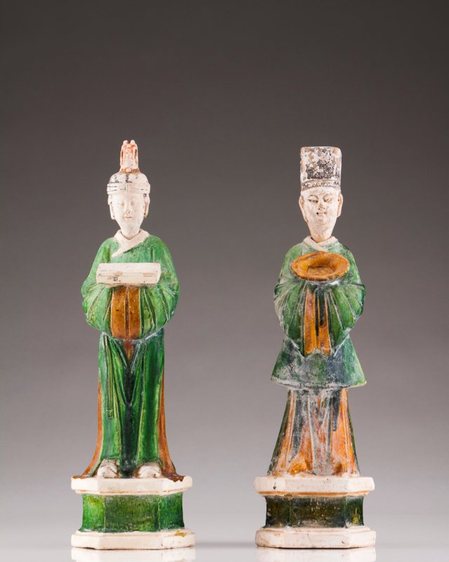 A pair of Ming stoneware sculptures of offering carriers 